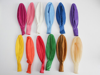 multi-colored latex balloons on a white background