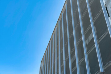 Fototapeta na wymiar Office building exterior with cloudless blue sky background on a sunny day