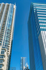 Fototapeta premium Towering skyscrapers in downtown Austin Texas with vibrant blue sky background