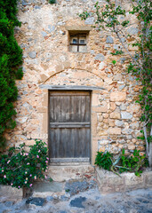 Fototapeta na wymiar Medieval wooden door of stone building in Monemvasia, Greece