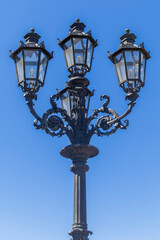 Fototapeta na wymiar vintage street lamp on a blue sky background
