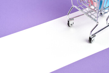 Shopping concept, back of a grocery cart with paper bags on a pastel lilac and white background. Design with copy space. Market deals, seasonal sales and discounts, black friday advertising campaign.