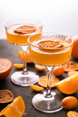 orange vodka tequila gin tonic mandarin cocktail with special cocktail glasses, dried oranges kumquats on background