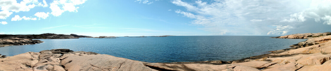 Fototapeta na wymiar panorama of coastline with cliffs, sea and blue sky