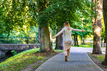 Beautiful woman walking in city park
