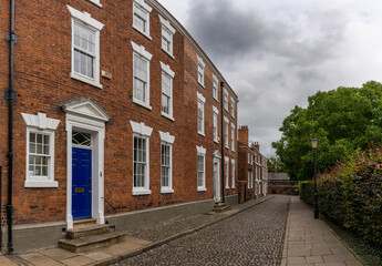 red brick buildings with colorful doors in typical English fashion in the historic city center of Chester