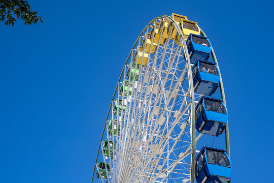 Part of a big colorful vivid ferris wheel on a bright sunny day