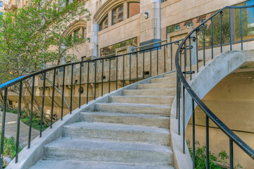 Stairs going up to buildings and bridge overlooking the San Antonio River Walk