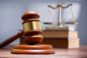 gavel hammer with libra scale and stack of books
