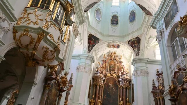 Salzburg, Austria, August 2022. Beautiful pan footage of the magnificent interior of the Abbey of St. Peter the Apostle in Salzburg. Shot in the direction of the altar and pulpits.