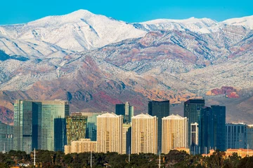 Poster Las Vegas skyline in winter with snow capped mountain. © John