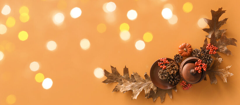 Beautiful autumn table setting on orange background with space for text - Powered by Adobe