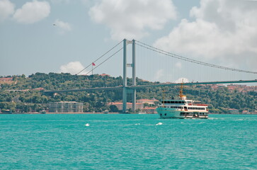 boat under the bosphorus bridge