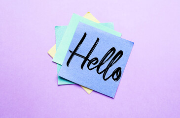 Sticky note with word HELLO on lilac background