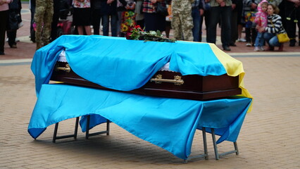 Ukraine. War. The funeral ceremony of a soldier. Funeral ceremony. The funeral of Ukrainian soldiers who died during the Russian invasion of Ukraine. Coffin decorated with flowers.