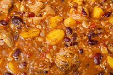 Chelnt with chicken with beans, dates and raisins close-up.