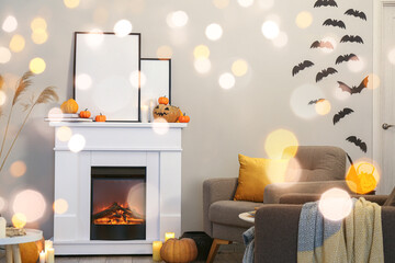 Interior of light living room with fireplace and Halloween decorations