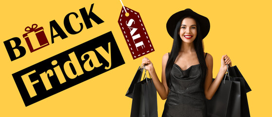Beautiful young woman with shopping bags on yellow background. Black Friday sale