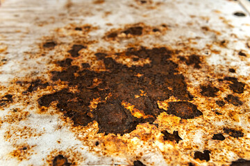 white old rusty metal sheet background. solid strong metal panel with dark brown corrison rust spot on surface. a dry rough white color steel barrier material board have old bad dirty rustic texture