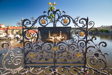 Iron forged grid with Saint John of Nepomuk relief on Charles Bridge in Prague, Czech Republic.