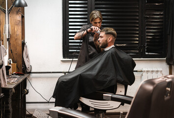 Adult bearded man in the hairdressing salon.