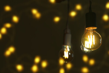 Glowing light bulbs on dark background