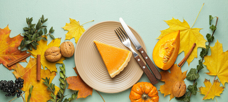 Composition with tasty pumpkin pie and autumn leaves on color background, top view