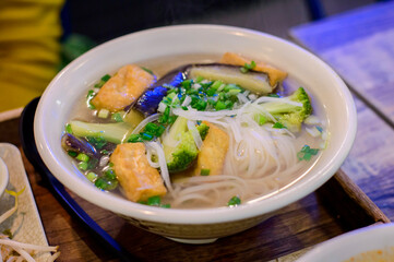 Top view of Vietnamese pho with tofu and vegetable soup.
