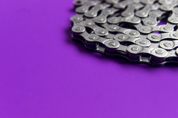 Bicycle chain on purple background. Selective focus and copy space