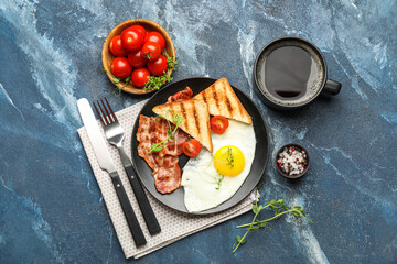 Composition with plate of tasty fried egg, bacon, toasts and coffee on color background