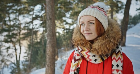 Smiling woman in forest in winter