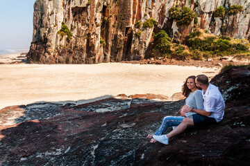 Pregnant couple dancing at sunset