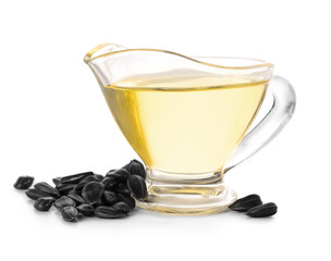 Gravy boat with oil and sunflower seeds on white background