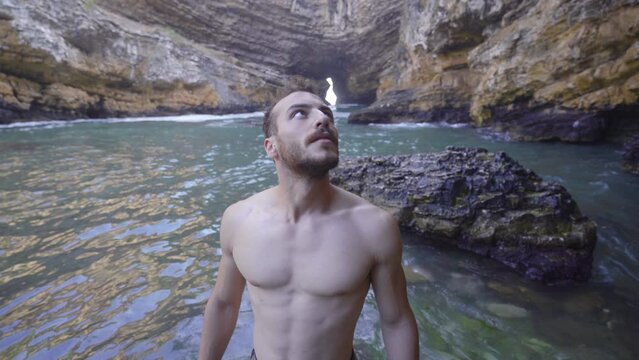 Young man walking on sea cliffs.
The young man walking in the sea bay admires the fascinating view.
