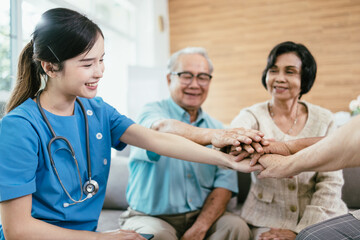 Fototapeta premium Happy Asian elderly people hands join together in the middle with young woman nursing elderly care.