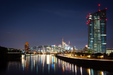 Frankfurt city at night with light reflections in the river.
