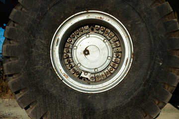 Large wheel of a heavy truck crane, close-up. Large wheel of cargo vehicles.