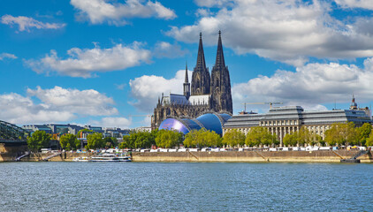 Cologne, Germany - July 9. 2022: View over river rhine on gothic dom towers and musical dome in summer © Ralf