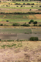 Fototapeta premium Aerial views of green scenery of farms, mountains, and rivers some with horses and cows.