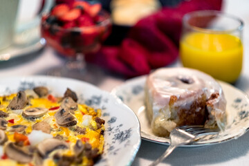 Fototapeta na wymiar Breakfast frittata and cinnamon roll with orange juice