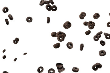 Chocolate rings cereal spill out into a bowl. Breakfast.