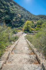 Fototapeta na wymiar Outdoor rock stairs on a mountain slope at Sabino Canyon State Park- Tucson, Arizona