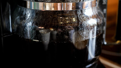 Close up of coffee dripping into a jug of an overflow coffee maker - 529713639