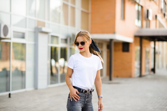 blonde girl in sunglasses, white t-shirt
