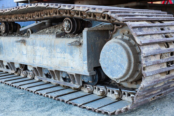 Fototapeta na wymiar Close-up of metal tracks of a crawler crane with steel wheels. Chassis tracked vehicles.