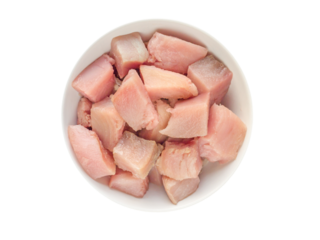 Albacore fish pieces prepared for marmitaco soup cooking in the bowl top view isolated transparent png