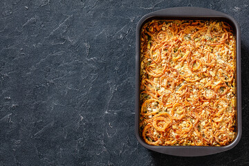 cheesy green bean casserole in dish, top view