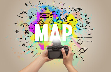 Close-up of a hand holding digital camera with abstract drawing