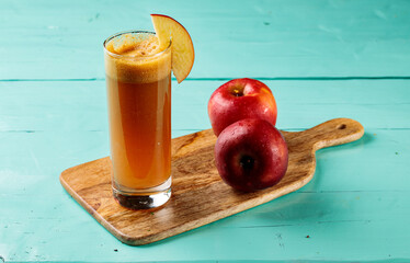 Fresh Apple Juice with raw apples served in a glass isolated on cutting board side view healthy...