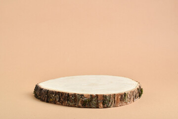 A minimalistic scene with a tree cut on a beige background. Podium for the presentation of products...